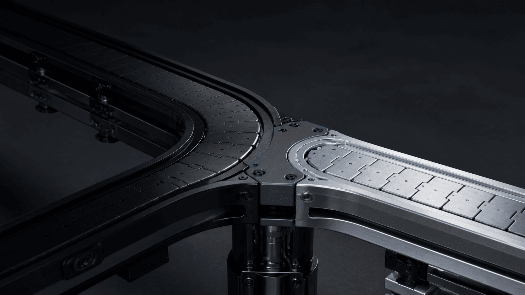 Two distinct conveyor systems meeting at an engineered junction